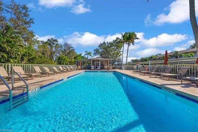 7320 Glenmoor Ln, #2304, Naples, FL 34104 Community pool with a patio area and a sunroom