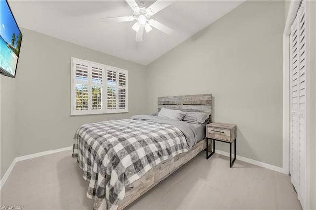 7320 Glenmoor Ln, #2304, Naples, FL 34104 Bedroom with vaulted ceiling and a ceiling fan