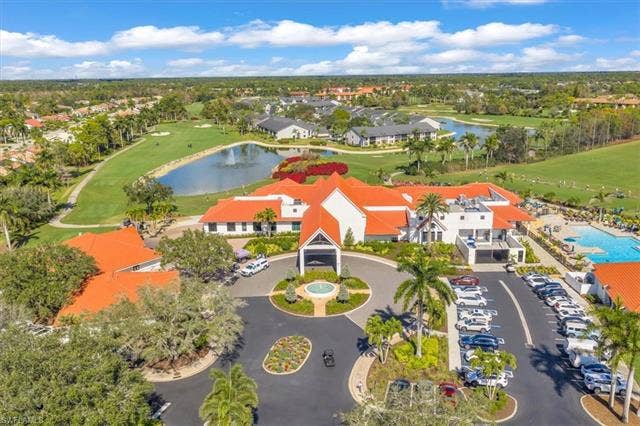 7320 Glenmoor Ln, #2304, Naples, FL 34104 Drone / aerial view of a nearby body of water and a golf course