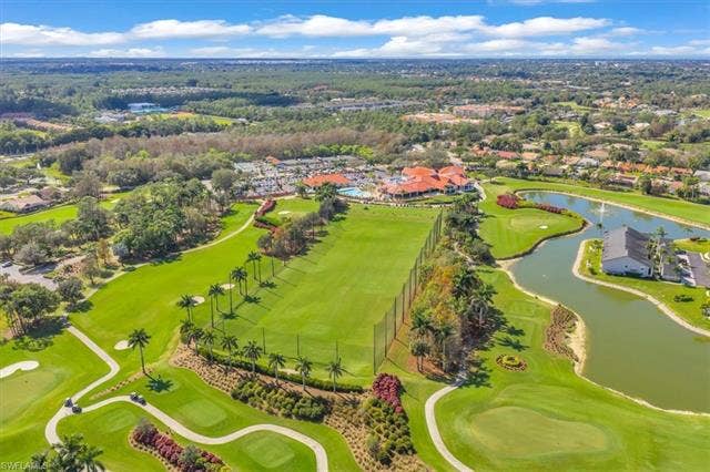 7320 Glenmoor Ln, #2304, Naples, FL 34104 Aerial perspective of suburban area featuring a large body of water and a golf club