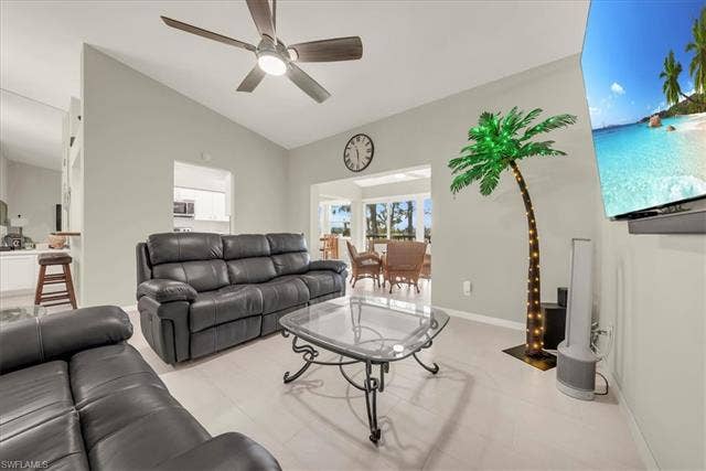 7320 Glenmoor Ln, #2304, Naples, FL 34104 Living area featuring vaulted ceiling and ceiling fan