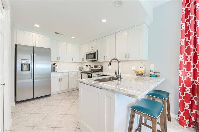 22971 Rosedale Dr, #101, Estero, FL 34135 NEW SHAKER CABINETRY WITH QUARTZ COUNTERTOPS, NEW LIGHTING AND NEW PLUMBING FIXTURES, AND STAINLESS STEEL APPLIANCES