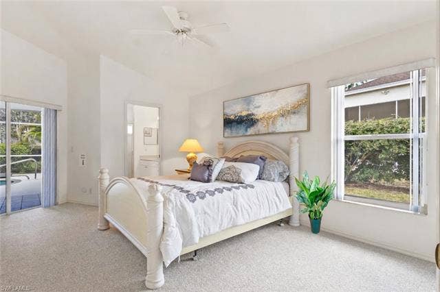 3650 Sunland Ln, Estero, FL 33928 Carpeted bedroom featuring access to outside, ceiling fan, and lofted ceiling