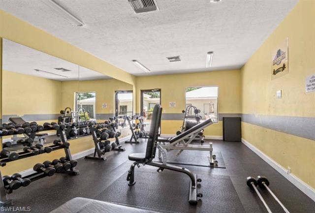 3650 Sunland Ln, Estero, FL 33928 Workout area featuring a textured ceiling