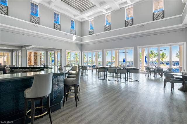 18500 Wildblue Blvd, Fort Myers, FL 33928 Bar area with coffered ceiling and dark countertops