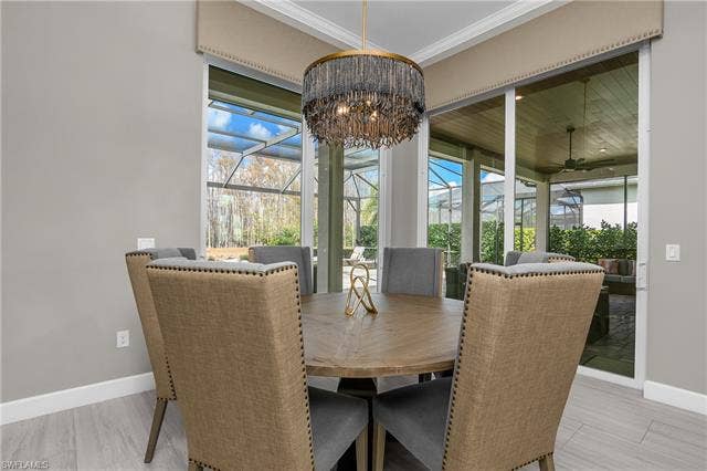 18500 Wildblue Blvd, Fort Myers, FL 33928 Dining area with a sunroom and ceiling fan