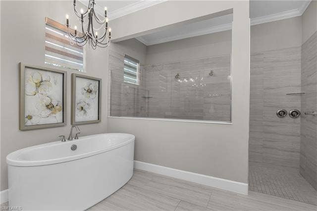 18500 Wildblue Blvd, Fort Myers, FL 33928 Full bath featuring walk in shower, crown molding, a chandelier, and a soaking tub