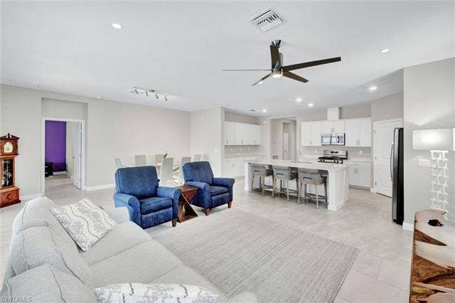 18298 Ridgeline Dr, Estero, FL 33928 Living area with a ceiling fan and recessed lighting