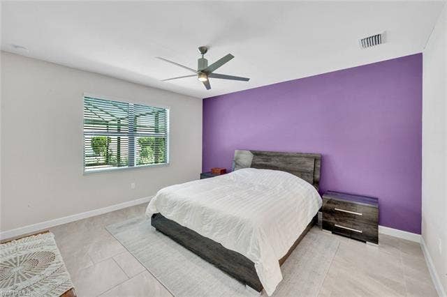 18298 Ridgeline Dr, Estero, FL 33928 Bedroom with a ceiling fan and an accent wall