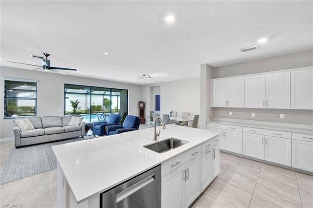 18298 Ridgeline Dr, Estero, FL 33928 Kitchen featuring white cabinetry, stainless steel dishwasher, an island with sink, ceiling fan, and recessed lighting