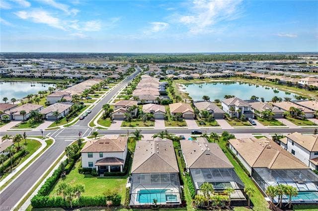 18298 Ridgeline Dr, Estero, FL 33928 Aerial perspective of suburban area with a large body of water