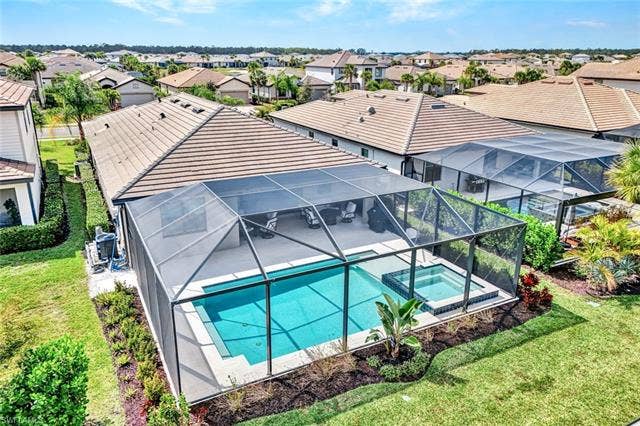 18298 Ridgeline Dr, Estero, FL 33928 Aerial perspective of suburban area featuring a pool area
