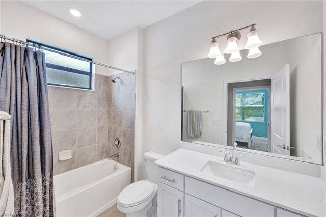 18298 Ridgeline Dr, Estero, FL 33928 Full bath with plenty of natural light, ensuite bathroom, vanity, and shower / tub combo