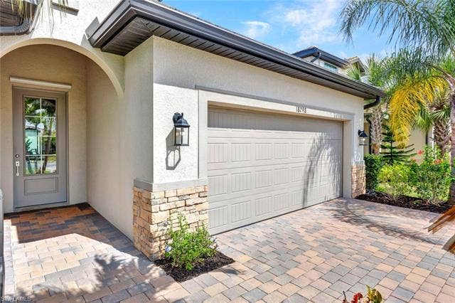 18298 Ridgeline Dr, Estero, FL 33928 Garage with decorative driveway