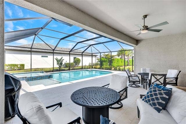 18298 Ridgeline Dr, Estero, FL 33928 Integrated pool / hot tub with a patio area, a sunroom, a lanai, and area for grilling