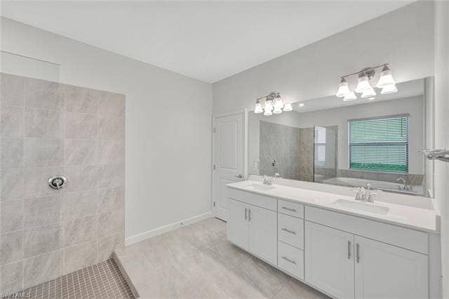 18298 Ridgeline Dr, Estero, FL 33928 Full bathroom with double vanity, walk in shower, and light tile patterned floors