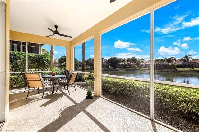 20667 Wildcat Run Dr, #101, Estero, FL 33928 Sunroom / solarium featuring outdoor dining space, a ceiling fan, and a water view
