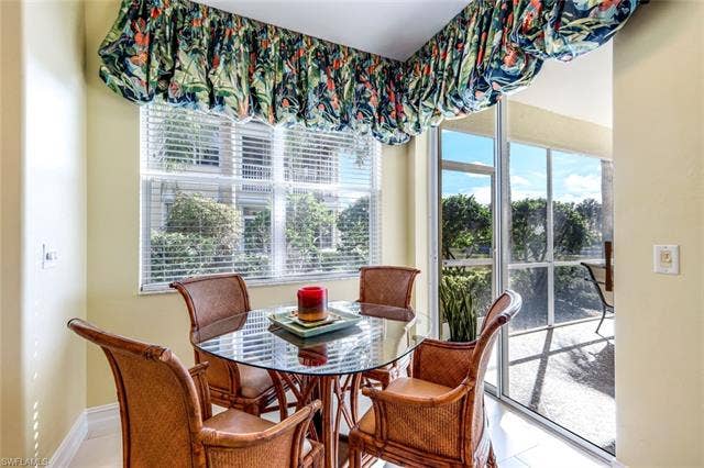 20667 Wildcat Run Dr, #101, Estero, FL 33928 Dining area featuring tile patterned floors and baseboards