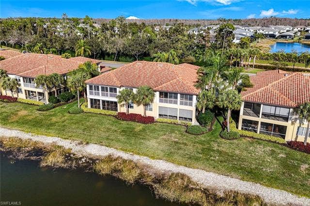 20667 Wildcat Run Dr, #101, Estero, FL 33928 Aerial perspective of suburban area with a nearby body of water