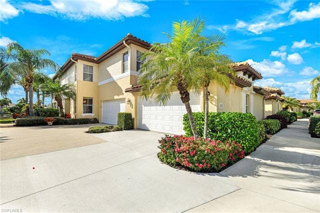 20667 Wildcat Run Dr, #101, Estero, FL 33928 Mediterranean / spanish home with concrete driveway, stucco siding, and a tiled roof