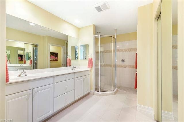 20667 Wildcat Run Dr, #101, Estero, FL 33928 Full bath with double vanity, a stall shower, light tile patterned floors, and recessed lighting
