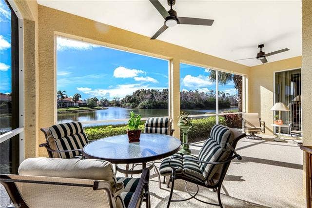 20667 Wildcat Run Dr, #101, Estero, FL 33928 Lanai featuring a water view and a textured wall