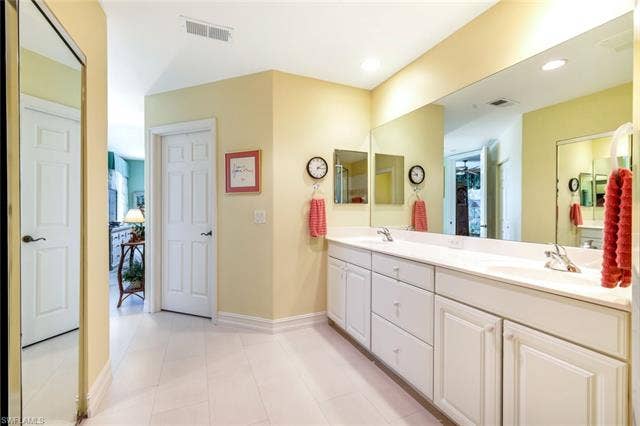 20667 Wildcat Run Dr, #101, Estero, FL 33928 Bathroom featuring double vanity, light tile patterned flooring, and recessed lighting
