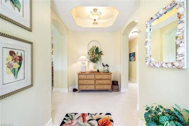 20667 Wildcat Run Dr, #101, Estero, FL 33928 Corridor with a tray ceiling and arched walkways