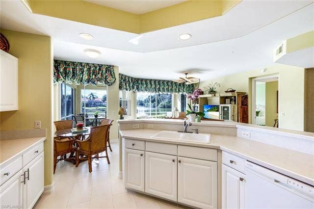 20667 Wildcat Run Dr, #101, Estero, FL 33928 Kitchen with dishwasher, white cabinetry, light countertops, and recessed lighting