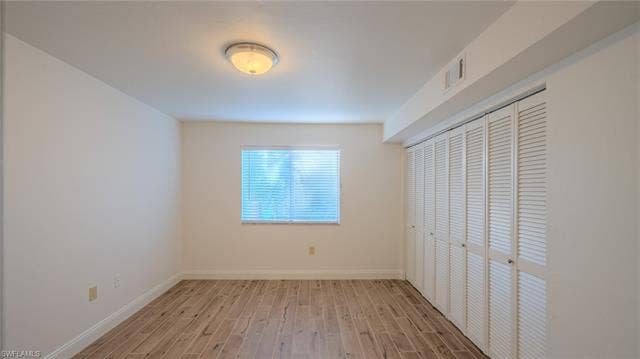 3160 Seasons Way, #709, Estero, FL 33928 Unfurnished bedroom with wood finish floors and a closet
