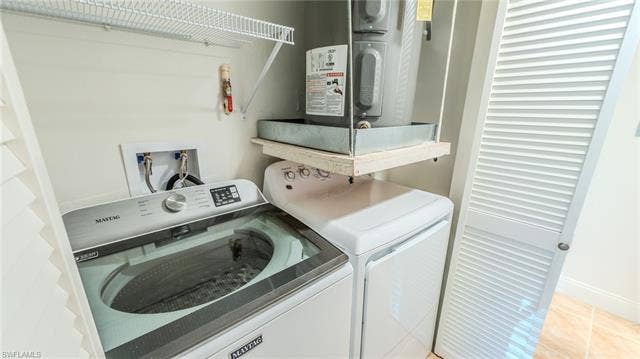 3160 Seasons Way, #709, Estero, FL 33928 Laundry area with separate washer and dryer and baseboards