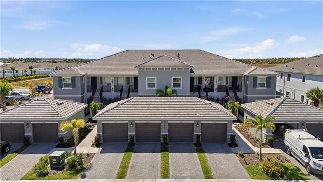 11861 Venetian Lagoon Dr, #203, Fort Myers, FL 33913 Rear view of house with a tile roof, stucco siding, and a residential view