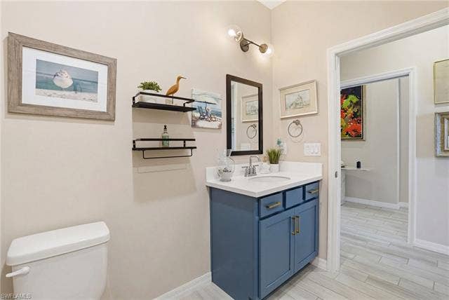 11861 Venetian Lagoon Dr, #203, Fort Myers, FL 33913 Half bath featuring vanity and wood finish floors