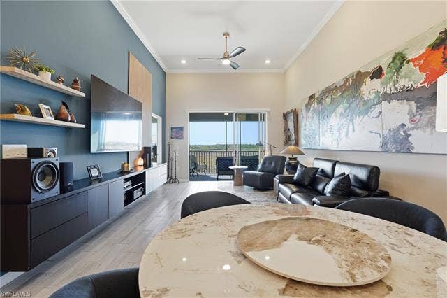 11861 Venetian Lagoon Dr, #203, Fort Myers, FL 33913 Living area featuring a ceiling fan, a high ceiling, light wood-style flooring, crown molding, and recessed lighting