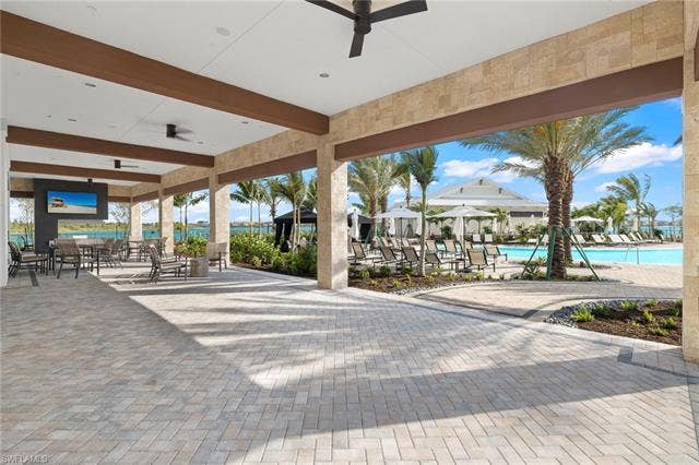 11861 Venetian Lagoon Dr, #203, Fort Myers, FL 33913 View of patio / terrace with a ceiling fan and a community pool