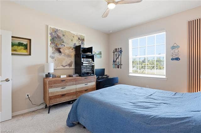 11861 Venetian Lagoon Dr, #203, Fort Myers, FL 33913 Bedroom with carpet and a ceiling fan