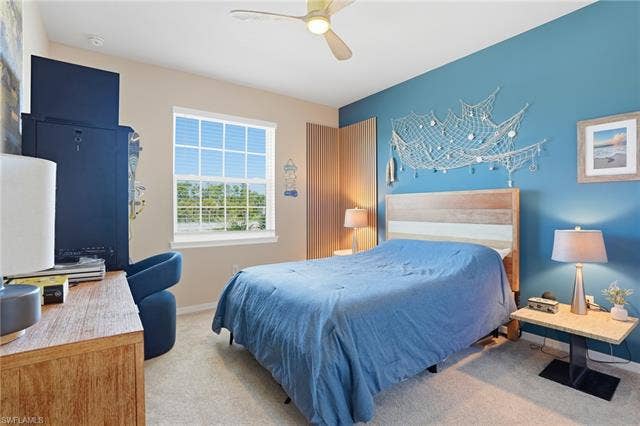 11861 Venetian Lagoon Dr, #203, Fort Myers, FL 33913 Bedroom with light carpet and ceiling fan
