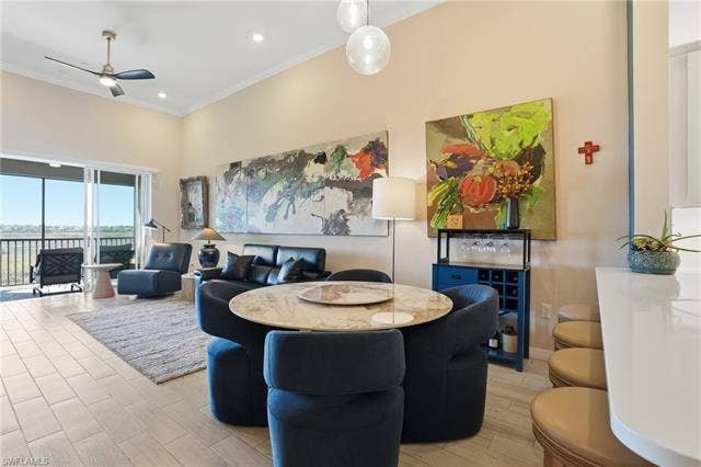 11861 Venetian Lagoon Dr, #203, Fort Myers, FL 33913 Dining area featuring ceiling fan, crown molding, wood tiled floors, recessed lighting, and a high ceiling
