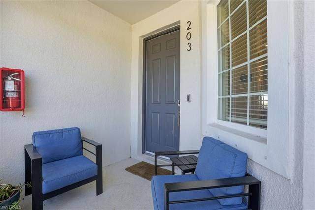 11861 Venetian Lagoon Dr, #203, Fort Myers, FL 33913 Entrance to property with stucco siding and covered porch