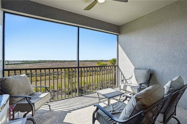 11861 Venetian Lagoon Dr, #203, Fort Myers, FL 33913 Sunroom with a ceiling fan and a balcony