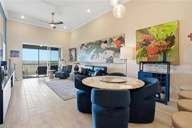 11861 Venetian Lagoon Dr, #203, Fort Myers, FL 33913 Dining room featuring wood finish floors, a ceiling fan, crown molding, recessed lighting, and a high ceiling