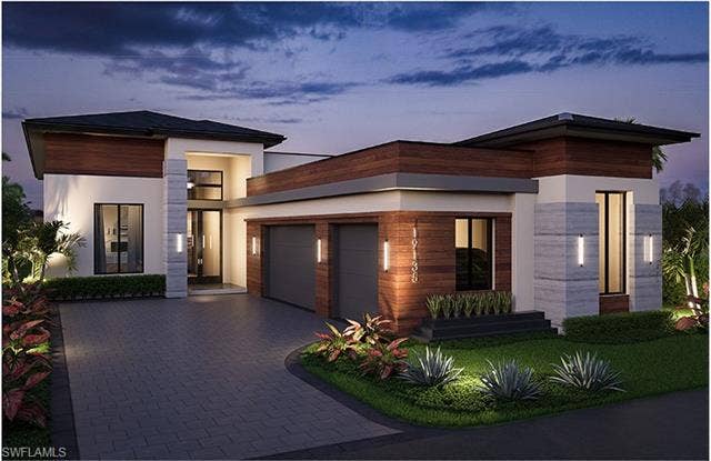 19135 Via Messina Way, Miromar Lakes, FL 33913 Modern home featuring an attached garage, decorative driveway, and stucco siding