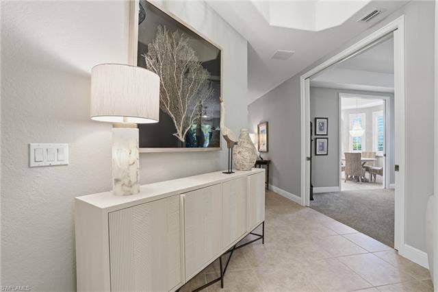 19620 Marino Lake Cir, #2802, Miromar Lakes, FL 33913 Corridor with light carpet and light tile patterned floors