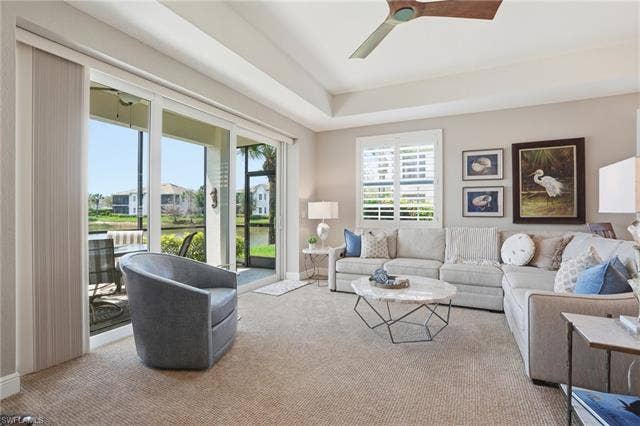 19620 Marino Lake Cir, #2802, Miromar Lakes, FL 33913 Living room featuring ceiling fan, carpet, and a water view