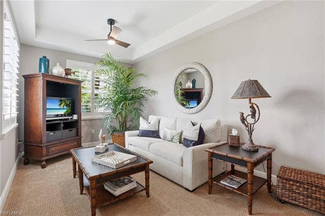19620 Marino Lake Cir, #2802, Miromar Lakes, FL 33913 Carpeted living room featuring a tray ceiling and ceiling fan
