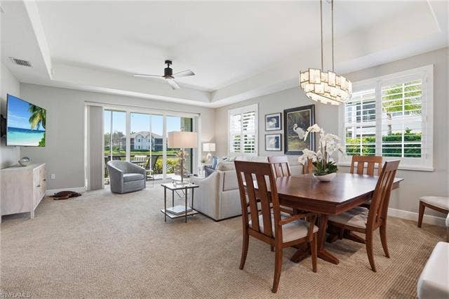 19620 Marino Lake Cir, #2802, Miromar Lakes, FL 33913 Dining area with a raised ceiling, ceiling fan, and light colored carpet