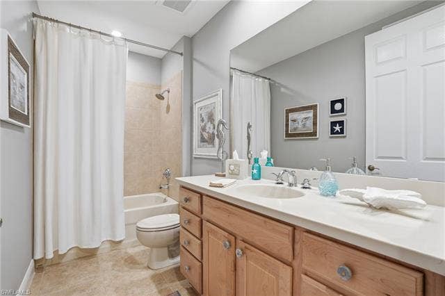 19620 Marino Lake Cir, #2802, Miromar Lakes, FL 33913 Full bathroom featuring vanity, shower / tub combo, and light tile patterned flooring