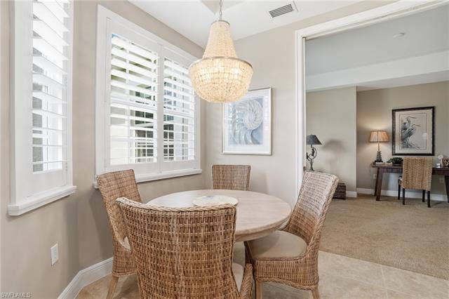 19620 Marino Lake Cir, #2802, Miromar Lakes, FL 33913 Dining space featuring baseboards and light colored carpet