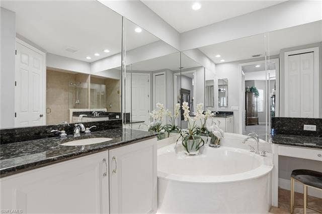 19620 Marino Lake Cir, #2802, Miromar Lakes, FL 33913 Bathroom with a closet, vanity, a tile shower, and a bath