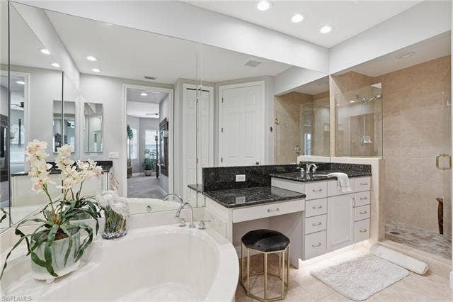 19620 Marino Lake Cir, #2802, Miromar Lakes, FL 33913 Full bathroom with vanity, a stall shower, a garden tub, and recessed lighting